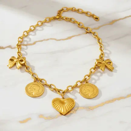Gold charm necklace on marble