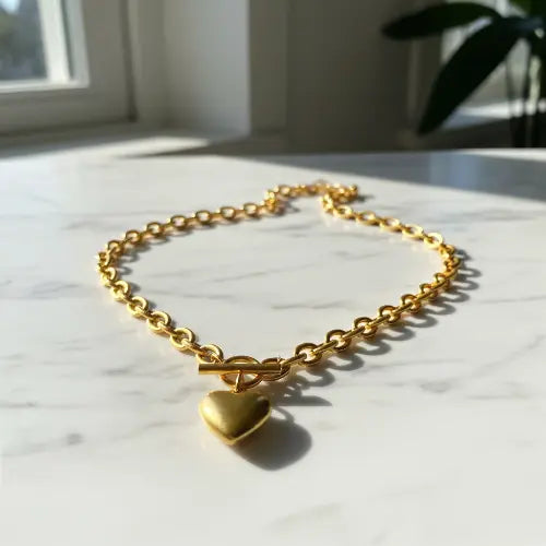 Gold heart necklace on marble