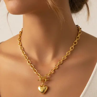 Gold heart necklace worn by model