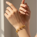 Gold knot bracelet on wrist