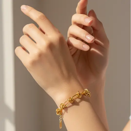 Gold knot bracelet on wrist