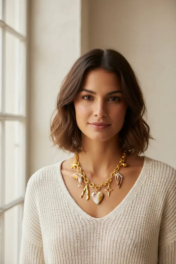 Model wearing gold charm necklace