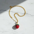 Strawberry necklace on marble